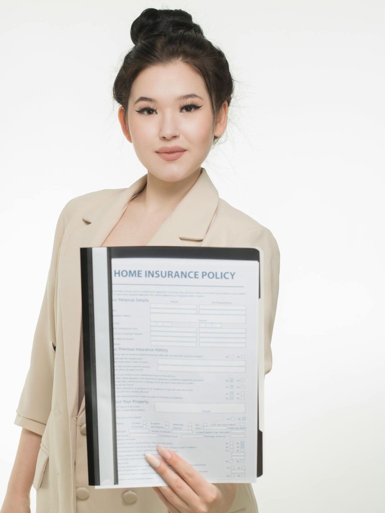 Professional woman presenting a home insurance policy document with a confident smile
