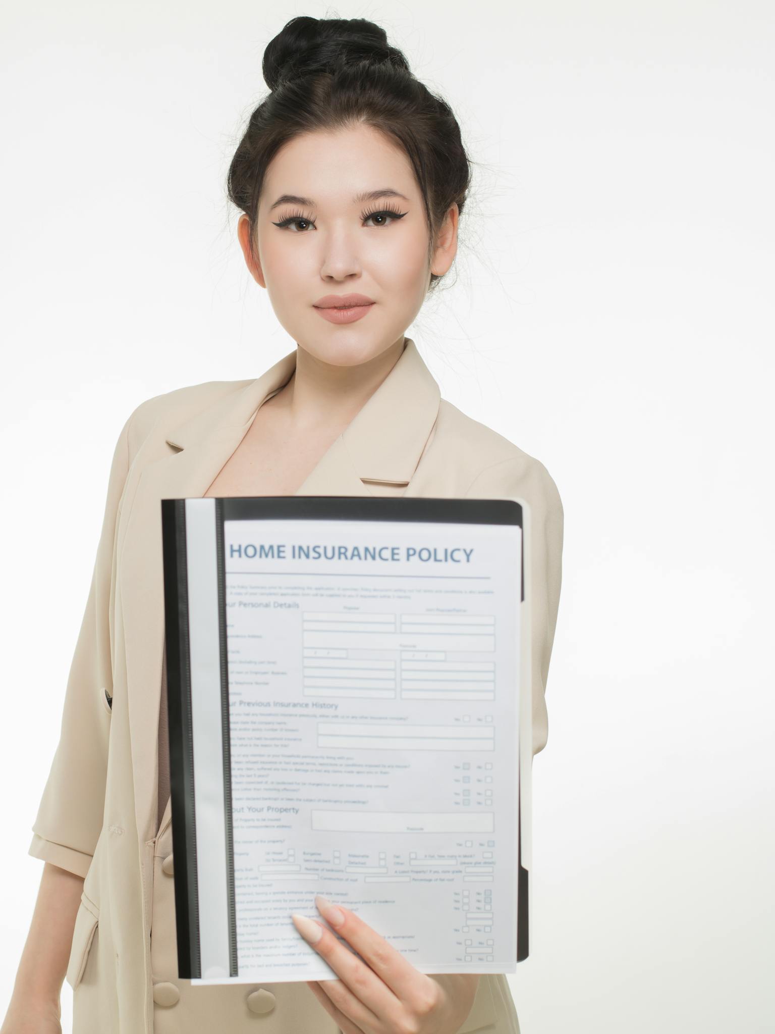 Professional woman presenting a home insurance policy document with a confident smile
